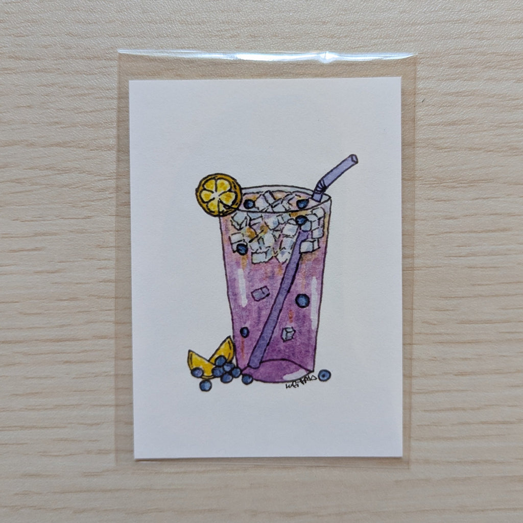 A small illustrated art print of a purple iced drink with a straw, lemon slice, and blueberries, on a light wood background.